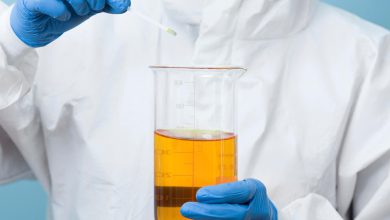 front-view-scientist-holding-yellow-chemical_23-2148697236